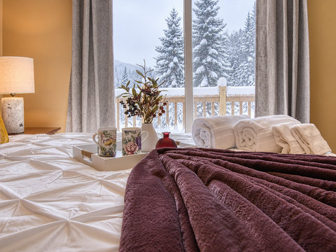 Cozy bedroom with snowy mountain views and warm, inviting touches