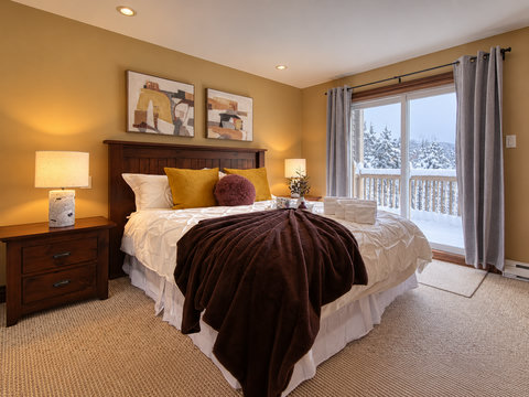 Cozy bedroom with private deck and serene snowy views