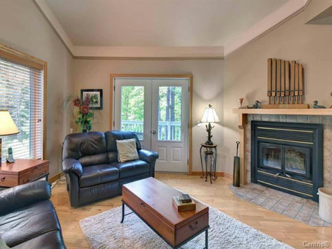 Living room with fireplace, TV and direct balcony access