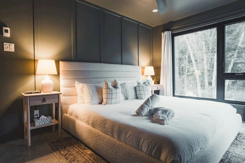 Sleep in style and comfort. The spacious primary bedroom offers soft textures, natural light, and calming forest views, no alarm needed.


