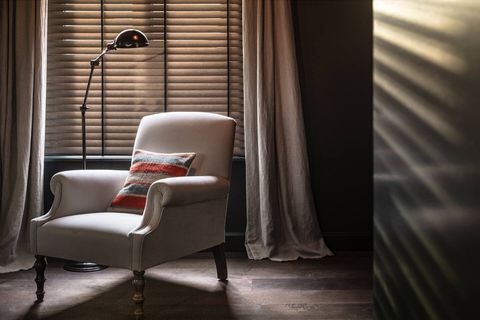 Gatsy styled arm chair with standing light ideally for reading.Entrance bathroom on the right.