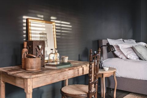 Scenery of the bedroom with desk and kingsize bed.