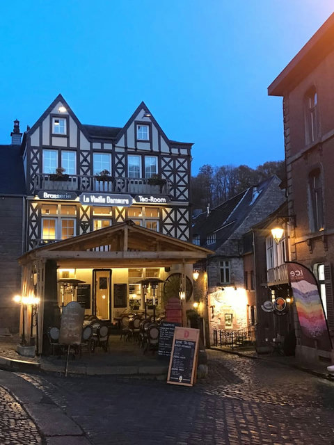 Durbuy's landmarks, including the castle and ancient churches, stood against the autumn sky, their silhouettes etched with the essence of time. The Ourthe River mirrored the changing landscape, reflecting the fiery colors that painted the trees.