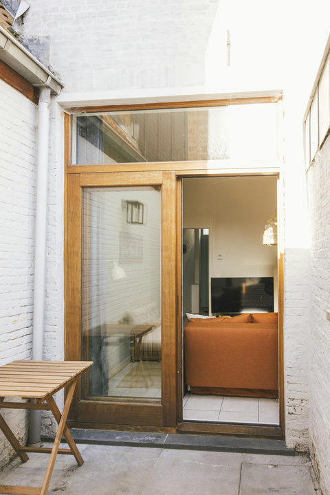 The courtyard connects directly to the living room through large glass doors
