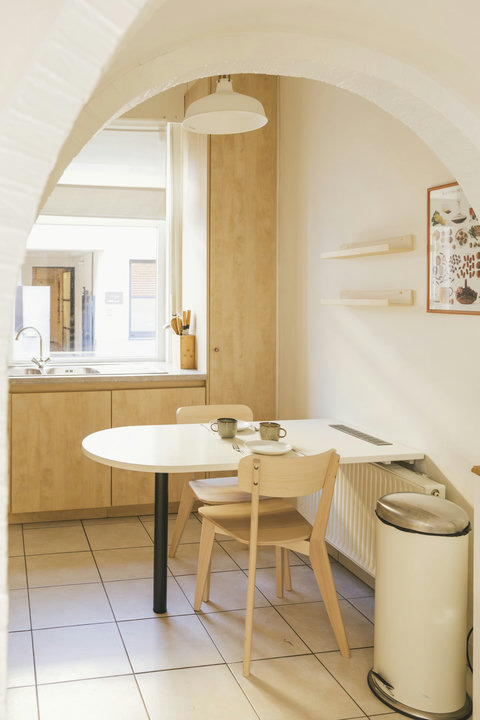Bright kitchen and breakfast nook under the original arch, with everything provided for self-catering