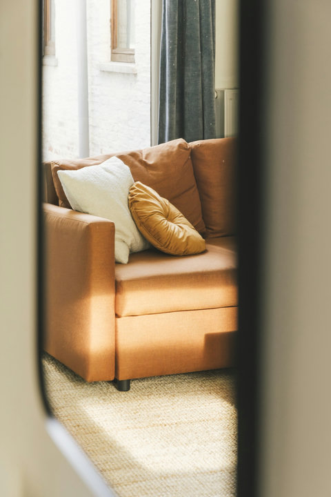 Comfortable sofa bathed in afternoon light — the perfect spot to unwind after sightseeing