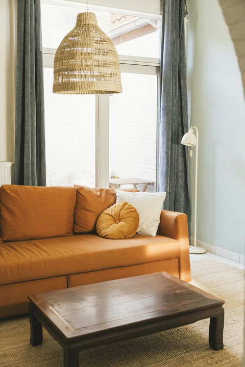 Cosy living room with comfortable sofa and garden doors opening onto the private courtyard