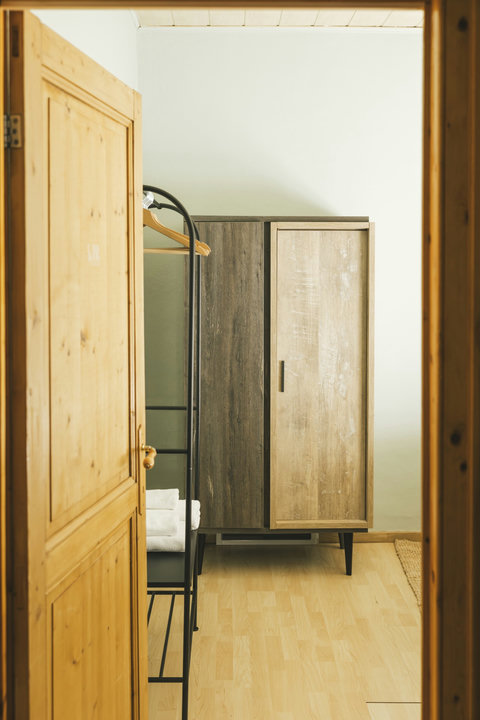 Bedroom with spacious wardrobe and luggage rack — plenty of storage for longer stays