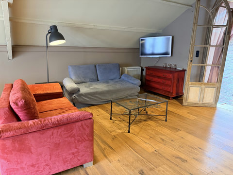 Ruime zithoek op de bovenverdieping met plaats voor vier gasten, voorzien van tv en sfeervolle verlichting. Perfect om te relaxen na gebruik van jacuzzi en sauna.