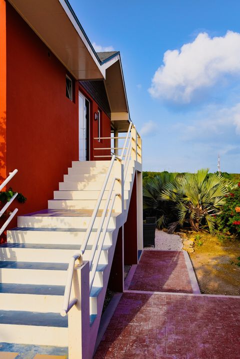 Side of the house with stairs leading upstairs.