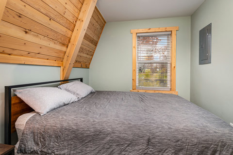 bedroom 1 with a queen bed on first floor