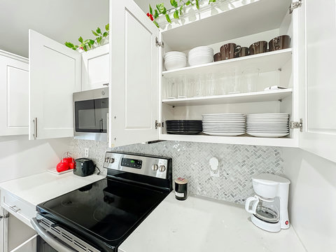 Fully equipped kitchen with dishwasher, oven, microwave, Fridge, Silverware, Pans pots, cups, dishes, seasonings, filtered water in fridge, coffee machine, espresso machine and coffee provided, toaster.