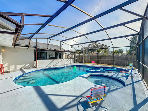 Heated Pool and Spa/Jacuzzi with toys floating devices,  beach chairs and mosquito net fence for confort.