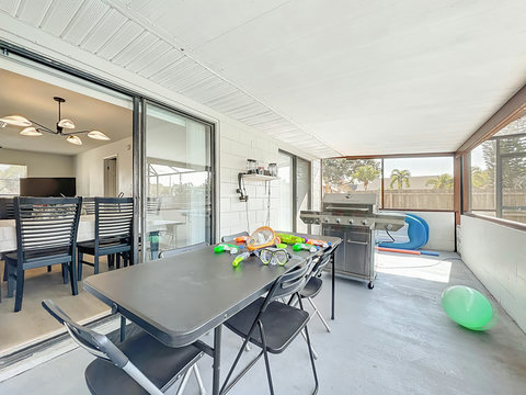 Outside dining area with a BBQ, Speaker and pool toys.