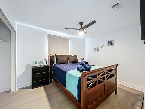 Bedroom with Queen bed with smart Tv and closet