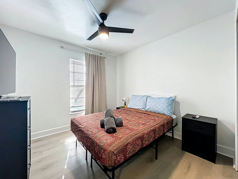 Bedroom with full bed with smart Tv and closet