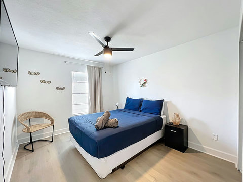 Bedroom with Queen bed with smart Tv and closet