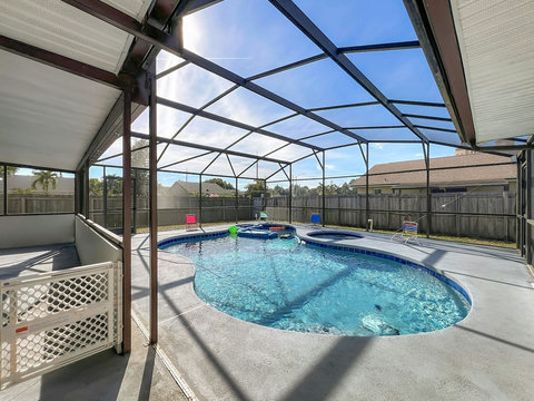 Heated Pool and Spa/Jacuzzi with toys floating devices,  beach chairs and mosquito net fence for confort.