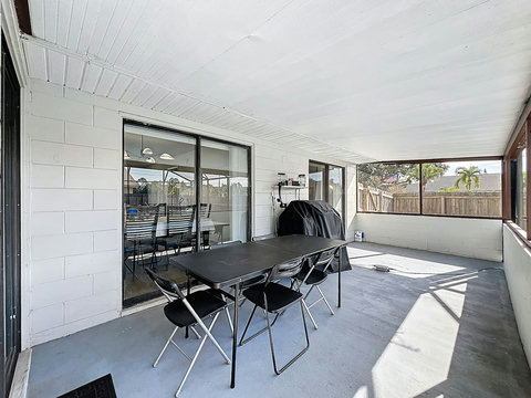 Outside dining area with a BBQ, Speaker and pool toys.