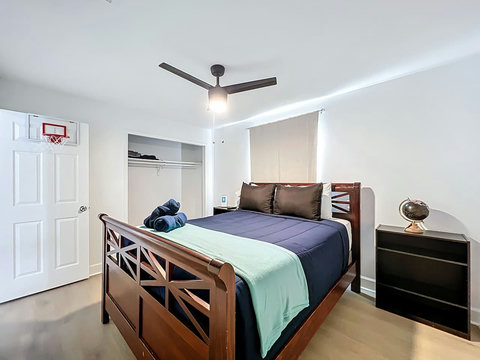 Bedroom with Queen bed with smart Tv and closet