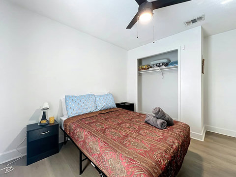 Bedroom with full bed with smart Tv and closet