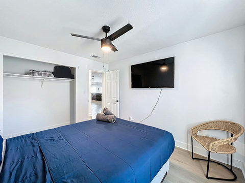 Bedroom with Queen bed with smart Tv and closet