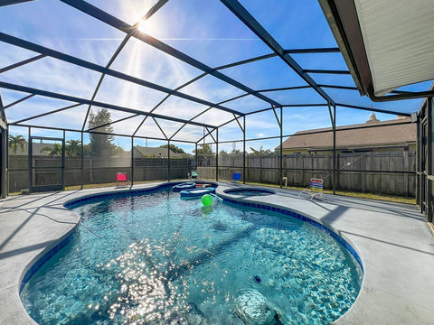 Heated Pool and Spa/Jacuzzi with toys floating devices,  beach chairs and mosquito net fence for confort.
