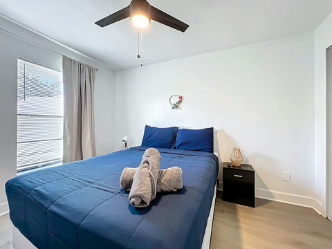 Bedroom with Queen bed with smart Tv and closet