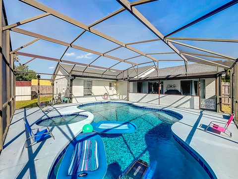 Heated Pool and Spa/Jacuzzi with toys floating devices,  beach chairs and mosquito net fence for confort.