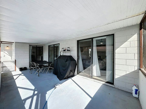 Outside dining area with a BBQ, Speaker and pool toys.