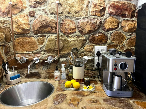 Private entrance to a fully equipped kitchenette with a sink and hot & cold water faucet, gas stove, fridge/freezer and microwave. Essential crockery, utensils and cookware, plus our easy-to-use craft coffee machine for great coffee anytime.