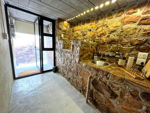 Private entrance to a fully equipped kitchenette with gas stove, fridge/freezer, microwave, essential crockery, utensils and cookware. Best of all, enjoy an easy-to-use craft coffee machine for your perfect morning brew.