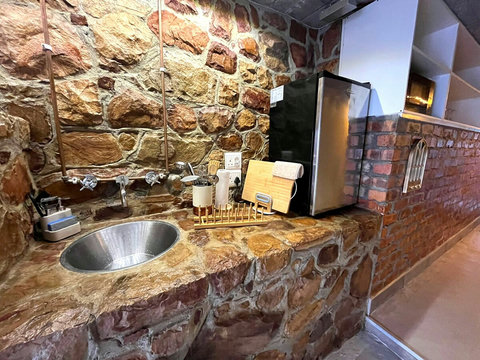 Private entrance to a fully equipped kitchenette with a sink and hot & cold water faucet, gas stove, fridge/freezer and microwave. Essential crockery, utensils and cookware, plus our easy-to-use craft coffee machine for great coffee anytime.