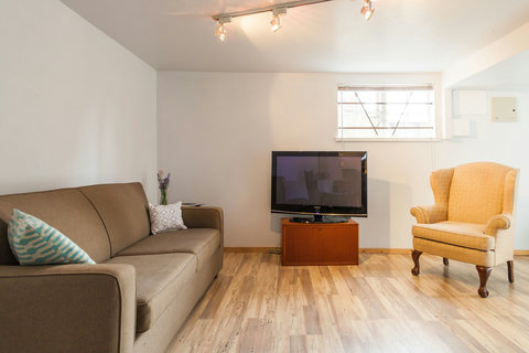 Pull out couch is a double. The TV has an cable and Chromecast for watching your Netflix, Youtube, etc

We've added a rug to the floor.