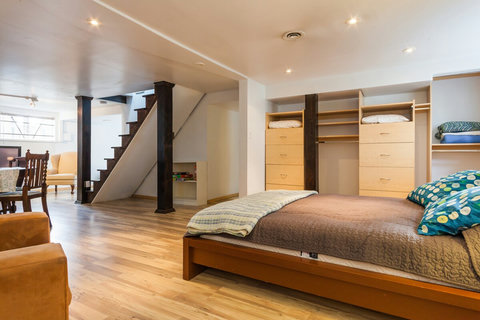 Nice open space. Next to the bed there is a dresser and extra pillows and blankets