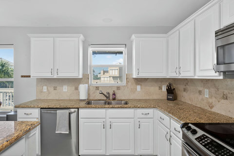 Kitchen includes dishwasher, oven & stove, & coffee maker