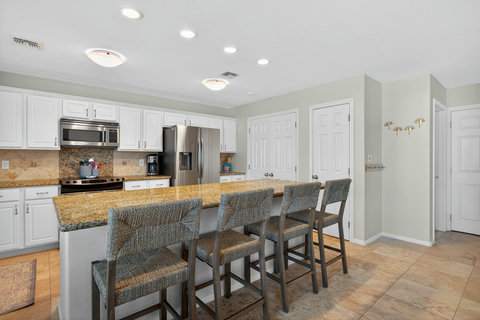 Full kitchen with stools at the large island