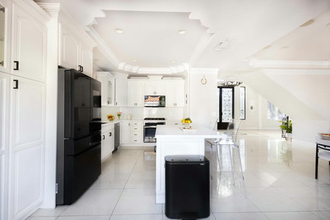 Fully equipped kitchen with dishwasher, stove, and prep space for cooking.