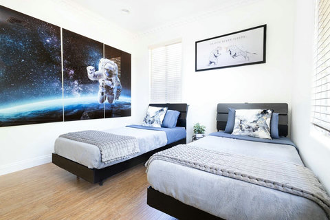 First floor guest room with two comfortable beds and a TV, perfect for relaxing after a long day.