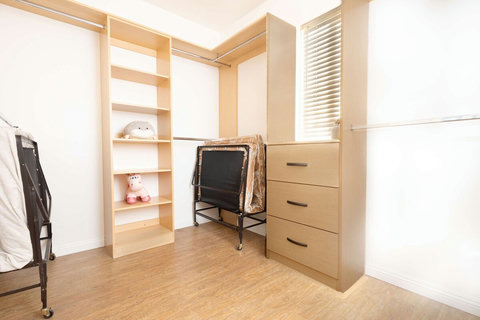Spacious walk in closet connected to the junior suite with built in shelving and storage space.