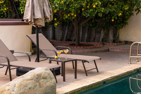 Poolside seating area near the citrus trees, a quiet spot to sit back and enjoy the outdoor setting.