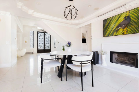 Event room with round dining table, fireplace, and views toward the grand entrance.