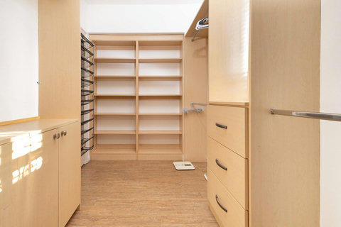 Spacious walk in closet in the master suite with built in shelving and storage.