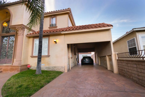 Extended driveway with a covered parking area, providing easy access and convenient off street parking.