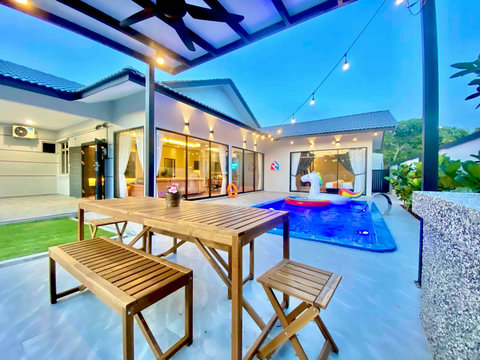 Outdoor dining area facing pool