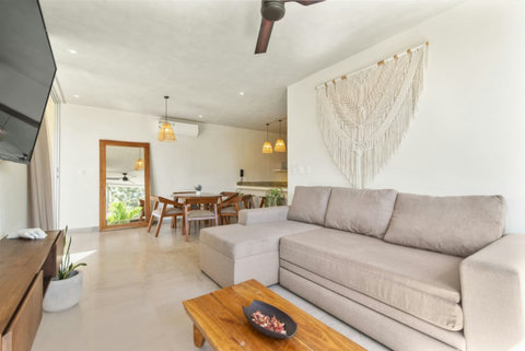 Enjoy movie nights in our spacious living room equipped with a large smart TV—perfect for winding down after adventures!  #MovieNight #TulumAdventures