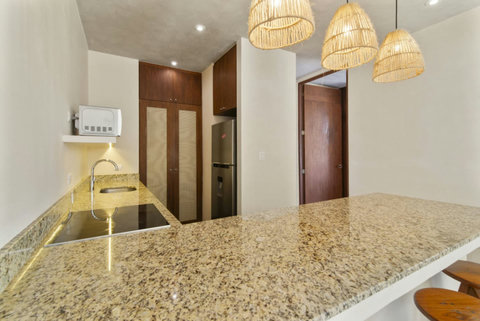 Cook in style in our modern kitchen, fully equipped with top appliances and ample space for your culinary creations during your Tulum getaway! ✨ #StylishKitchen #TulumCooking