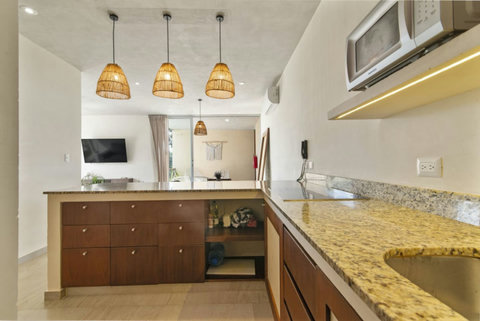 Cook in style in our modern kitchen, fully equipped with top appliances and plenty of space to create delicious meals during your Tulum getaway! ✨ #StylishKitchen #TulumCooking