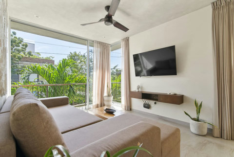 Kick back and relax in our cozy lounging area, complete with a large Smart TV for streaming your favorite shows and movies—perfect for winding down after a day of adventure!  #TulumEntertainment #CozyLiving #MovieNight