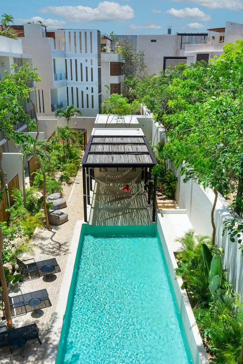 Enjoy lazy afternoons and sun-soaked days by the pool, complete with hammocks that invite you to lounge in comfort and style!  #PoolsideBliss #TulumLife #HammockHappiness